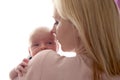 Loving mom holds her newborn baby in her arms, cute tiny baby. Portrait a Mom and her baby. The concept of a happy family Royalty Free Stock Photo