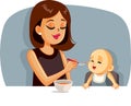 Happy Mother Feeding Her Baby Solid Food with a Spoon Royalty Free Stock Photo