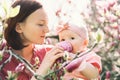 Mother and baby with blooming pink magnolia flower Royalty Free Stock Photo