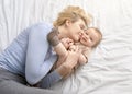 Loving mother caressing her baby boy on bed Royalty Free Stock Photo