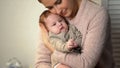 Loving mother cuddling little baby tenderly, newborn healthcare and patronage