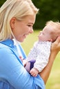 Loving Mother Holding Baby Daughter In Garden Royalty Free Stock Photo