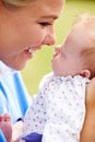 Loving Mother Holding Baby Daughter In Garden Royalty Free Stock Photo