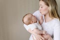 A loving mother holds, rocking, soothes her crying baby. A mother looks at her child with love and tenderness. Care Royalty Free Stock Photo