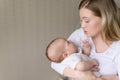 A loving mother holds, rocking, soothes her crying baby. A mother looks at her child with love and tenderness. Care Royalty Free Stock Photo