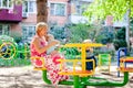 Loving mother hugs her little son in playground. Portrait of a beautiful mother with baby Royalty Free Stock Photo