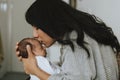 Loving mother kissing her infant baby Royalty Free Stock Photo