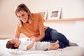 Loving Mother With Newborn Baby Lying On Bed At Home In Loft Apartment Royalty Free Stock Photo