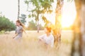 Loving mother plays with her daughter in the woods