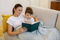 Loving Mother Reading Book To Her Cute Toddler Daughter At Home Royalty Free Stock Photo
