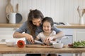 Loving young mother teach to cook her little adorable daughter Royalty Free Stock Photo