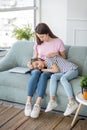 Loving mother touching her cute daughters head Royalty Free Stock Photo