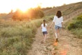 Loving mother walking with daughter in countryside Royalty Free Stock Photo