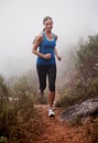 Loving my winter workout. a woman running on a trail on a misty morning. Royalty Free Stock Photo