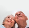 Loving older couple looking up with a smile