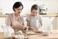 Loving older granny teach cute granddaughter to cook