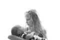 Loving older sister blonde sweetheart touching and gentle holds her newborn brother in her arms, cute tiny baby. Royalty Free Stock Photo