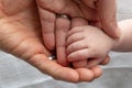 loving parents hands overlapping with their baby's hand holding their fingers Royalty Free Stock Photo