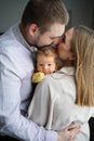 loving parents hold a baby and kiss. the happiness of fatherhood and motherhood. Royalty Free Stock Photo