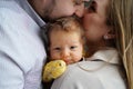 loving parents hold a baby and kiss. the happiness of fatherhood and motherhood.