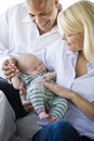 Loving parents holding baby sound asleep in arms Royalty Free Stock Photo