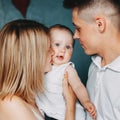 Loving parents hugging and kissing baby daughter Royalty Free Stock Photo