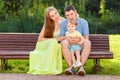 Loving parents with little girl on bench in park Royalty Free Stock Photo