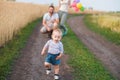 Loving parents watch their son doing first steps