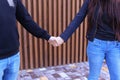 Loving people firmly hold hands and overcame each other, standin Royalty Free Stock Photo