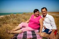 Loving Retired Couple Hugging Standing By Shore On Beach Vacation Royalty Free Stock Photo