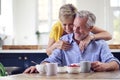 Loving Retired Couple Sitting Around Table At Home Having Healthy Breakfast Together Royalty Free Stock Photo