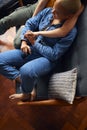 Loving Same Sex Female Couple Holding Hands Lying On Sofa At Home Watching TV And Relaxing Together Royalty Free Stock Photo