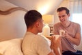 Loving Same Sex Male Couple In Bed At Home Drinking Hot Drink Together Royalty Free Stock Photo