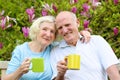 Loving senior couple drinking tea in the garden