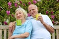 Loving senior couple drinking tea in the garden Royalty Free Stock Photo