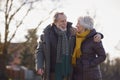 Loving Senior Couple Enjoying Autumn Or Winter Walk Through Park Together Royalty Free Stock Photo