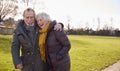 Loving Senior Couple Enjoying Autumn Or Winter Walk Through Park Together Royalty Free Stock Photo