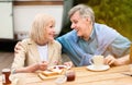 Loving senior couple having toasts with jam for breakfast at campground Royalty Free Stock Photo