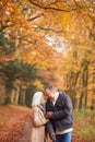 Loving Senior Couple Holding Hands As They Walk Along Autumn Woodland Path Through Trees Together Royalty Free Stock Photo