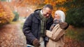 Loving Senior Couple Hugging As They Walk Along Autumn Woodland Path Through Trees Royalty Free Stock Photo