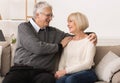 Loving senior couple relaxing on sofa at home Royalty Free Stock Photo