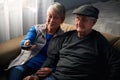 Loving Senior Couple Sitting On Sofa At Home Watching Television Together Royalty Free Stock Photo