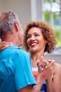 Loving Senior Couple On Summer Vacation Dancing Together In Holiday Apartment Royalty Free Stock Photo