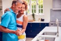 Loving Senior Couple On Summer Vacation Dancing Together In Holiday Apartment Royalty Free Stock Photo