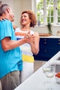 Loving Senior Couple On Summer Vacation Dancing Together In Holiday Apartment Royalty Free Stock Photo