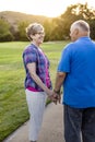 A loving senior couple on a walk together at sunset