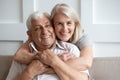 Loving senior husband and wife hugging looking at camera Royalty Free Stock Photo