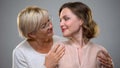 Loving senior mother and daughter looking at each other, tender female relations