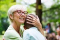 Loving senior woman embracing her grandchildren with a cheerful smile on her face Royalty Free Stock Photo