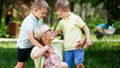 Loving senior woman embracing her grandchildren with a cheerful smile on her face Royalty Free Stock Photo